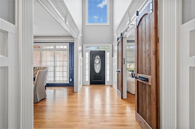 Entrance foyer featuring a barn door, light hardwo