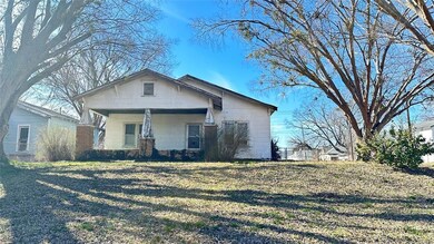 View of front facade with a front lawn and covered