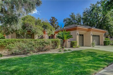 View of front of property featuring a front lawn, an attached garage, concrete driveway, and stucco siding