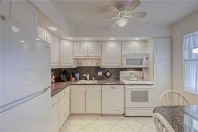 Kitchen offers high-hat lighting and ceiling fan w