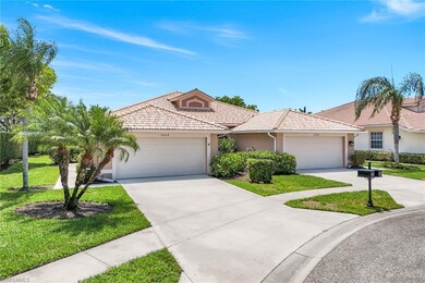 View of front of home with stucco siding, a garage, a tile roof, driveway, and a front yard