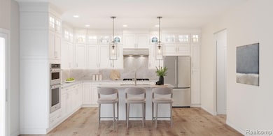 Kitchen featuring stainless steel appliances, white cabinets, a kitchen breakfast bar, tasteful backsplash, and hanging light fixtures