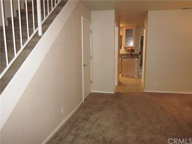 A Spacious living room closet under the stairs for