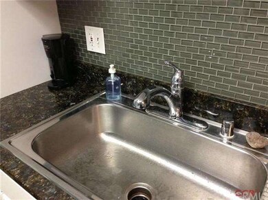 Large stainless steel sink and glass subway tile b