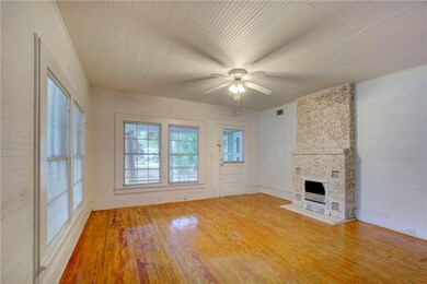 Hardwood flooring throughout with beadboard ceilin