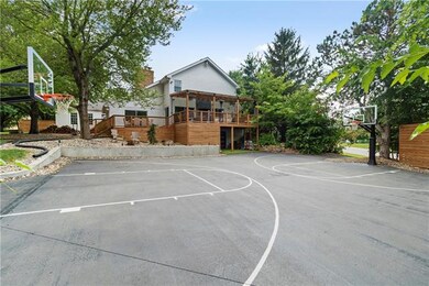 Full basketball court with two lifetime guarantee high end goals. New asphalt. Leads to third car garage and gym.
