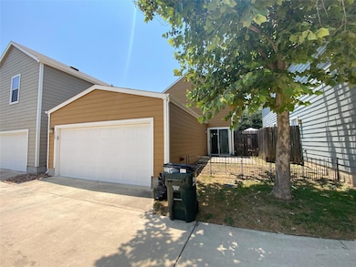 View of side of home featuring concrete driveway 