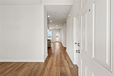 Corridor featuring light wood-style flooring and recessed lighting