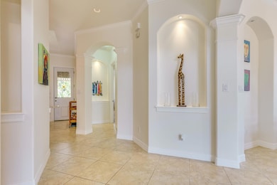 Hallway with tile patterned flooring, arched walk