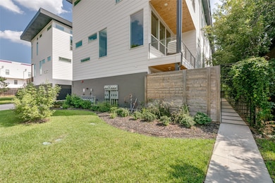 View of side of home with a balcony and brick siding