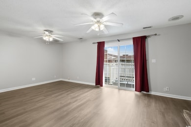 Unfurnished room with baseboards, wood finished fl
