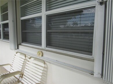 Newer windows and accordian shutters in front