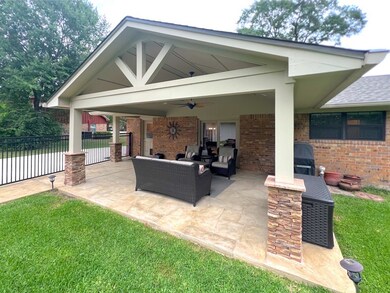 View of patio with fence, a ceiling fan, an outdoo