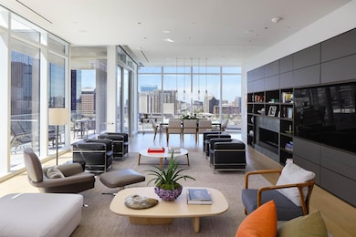 Living area with floor to ceiling windows and wood