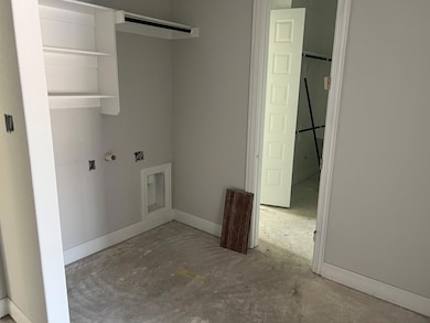 Laundry room featuring baseboards