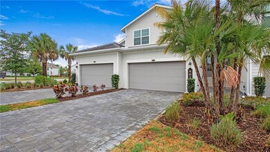 Traditional-style home featuring decorative driveway and an attached garage