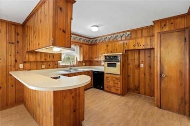 Kitchen with a breakfast bar, pantry, and cabinets