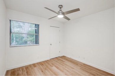 Unfurnished room with light wood-style flooring and a ceiling fan