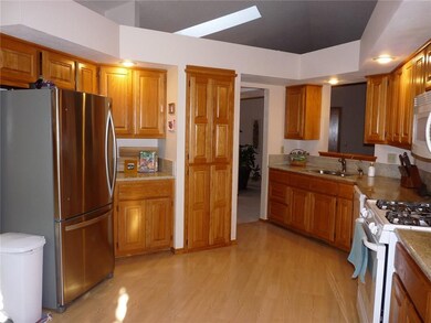 This spacious kitchen features granite counter tops and plenty of cabinets and counter top space.