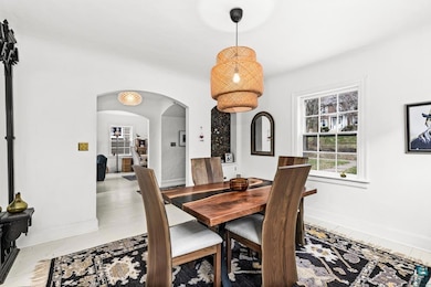 Dining area featuring arched walkways and baseboards