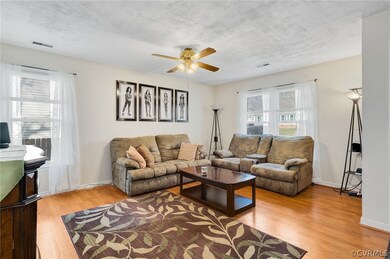Living room featuring ceiling fan and light hardwood / wood-style flooring