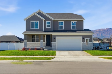 Craftsman-style home with a porch, concrete driveway, an attached garage, stone siding, and a mountain view