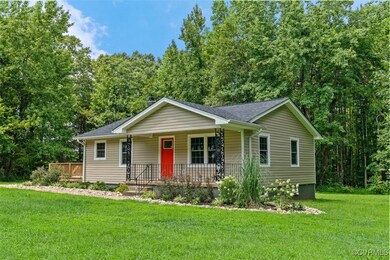 Ranch-style home with a front yard and covered por