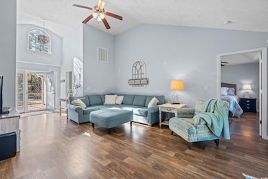 Living room with a textured ceiling, dark hardwood
