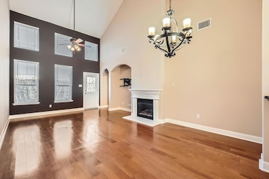 Unfurnished living room with arched walkways, a g