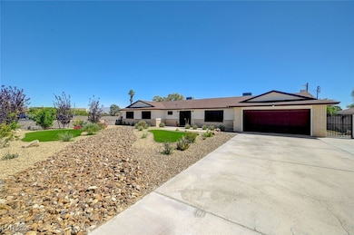Single story home featuring an attached garage, concrete driveway, and brick siding