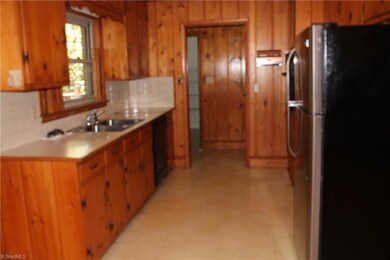 This is a view of the  kitchen which offers a refrigerator, smooth cooktop, built-in oven and dishwasher