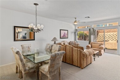 Carpeted dining area featuring ceiling fan with no