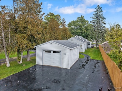 A large driveway welcomes you to the property, with a newer built 16'x20' custom garage (with power!) at the front. The paved walkway around the garage brings you to the front door of the home.