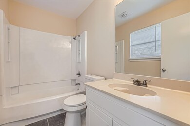 Bathroom featuring toilet, shower / bath combinat