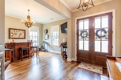 Large foyer with stained double doors