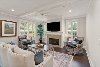 Spacious living area with fireplace and coffered c