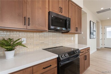 Kitchen featuring tasteful backsplash, black range