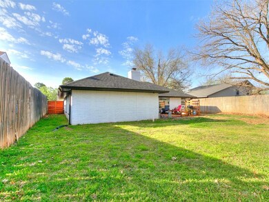 Back of house with a chimney, a fenced backyard, b
