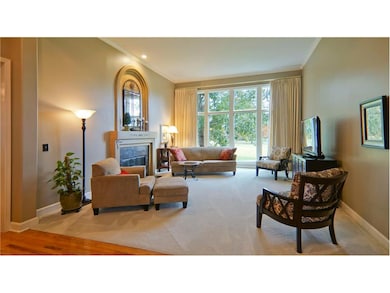 Great room with fireplace, upgraded carpets, and a