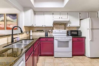 Kitchen with white appliances, a sink, under cabi
