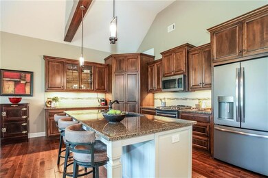 Well-equipped kitchen boasts a granite topped isla