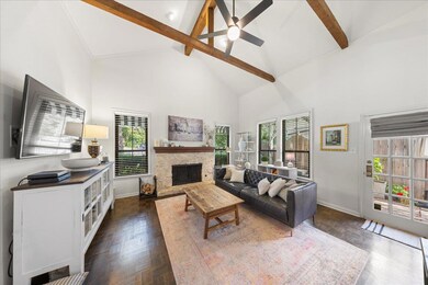Living room featuring high vaulted ceiling, beam 