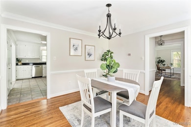 The dining room features hardwood flooring, a chan