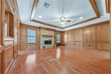 Unfurnished living room featuring a decorative wal