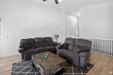 Living room with a ceiling fan and light wood-style flooring