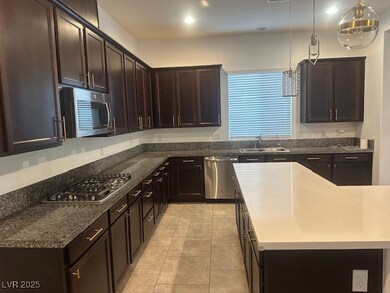 Kitchen with stainless steel appliances, a sink, d