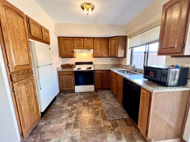 The kitchen has granite countertops, plenty of cab