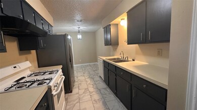 Kitchen featuring white appliances, light marble 