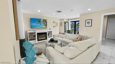 Living area featuring a glass covered fireplace and recessed lighting