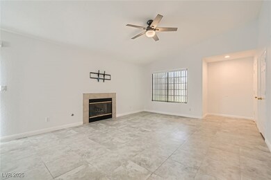 Unfurnished living room with a ceiling fan, a tile